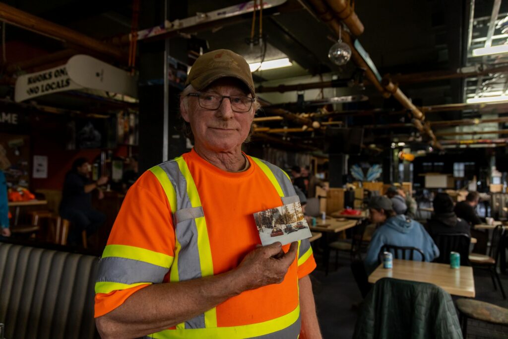 Dave holding a photo of a groomer.