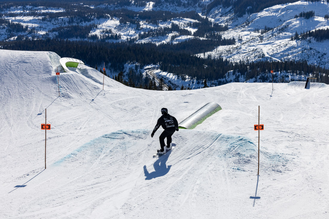 Rider jibbing a terrain park rail