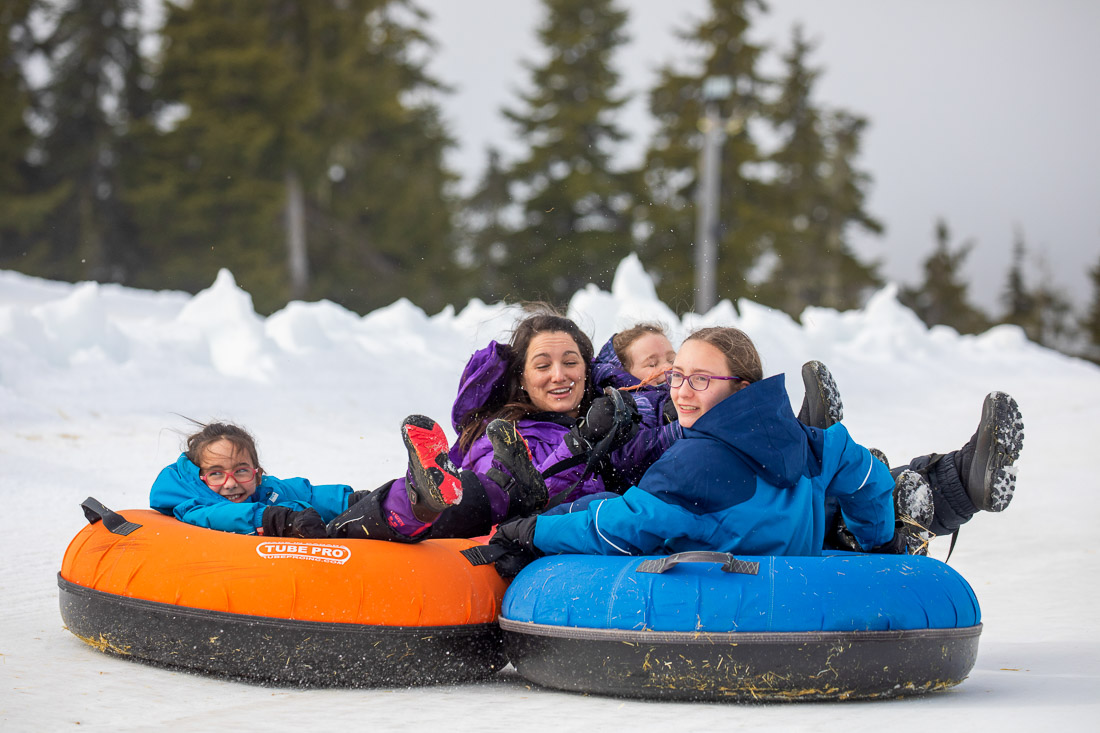 Group tubing down the hill