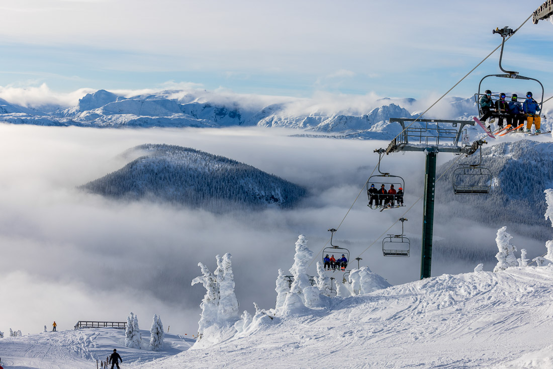 Chairlift rising over snow-laden trees at Mount Washington
